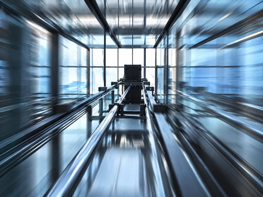 Elevator shaft in steel and glass, seen in motion
